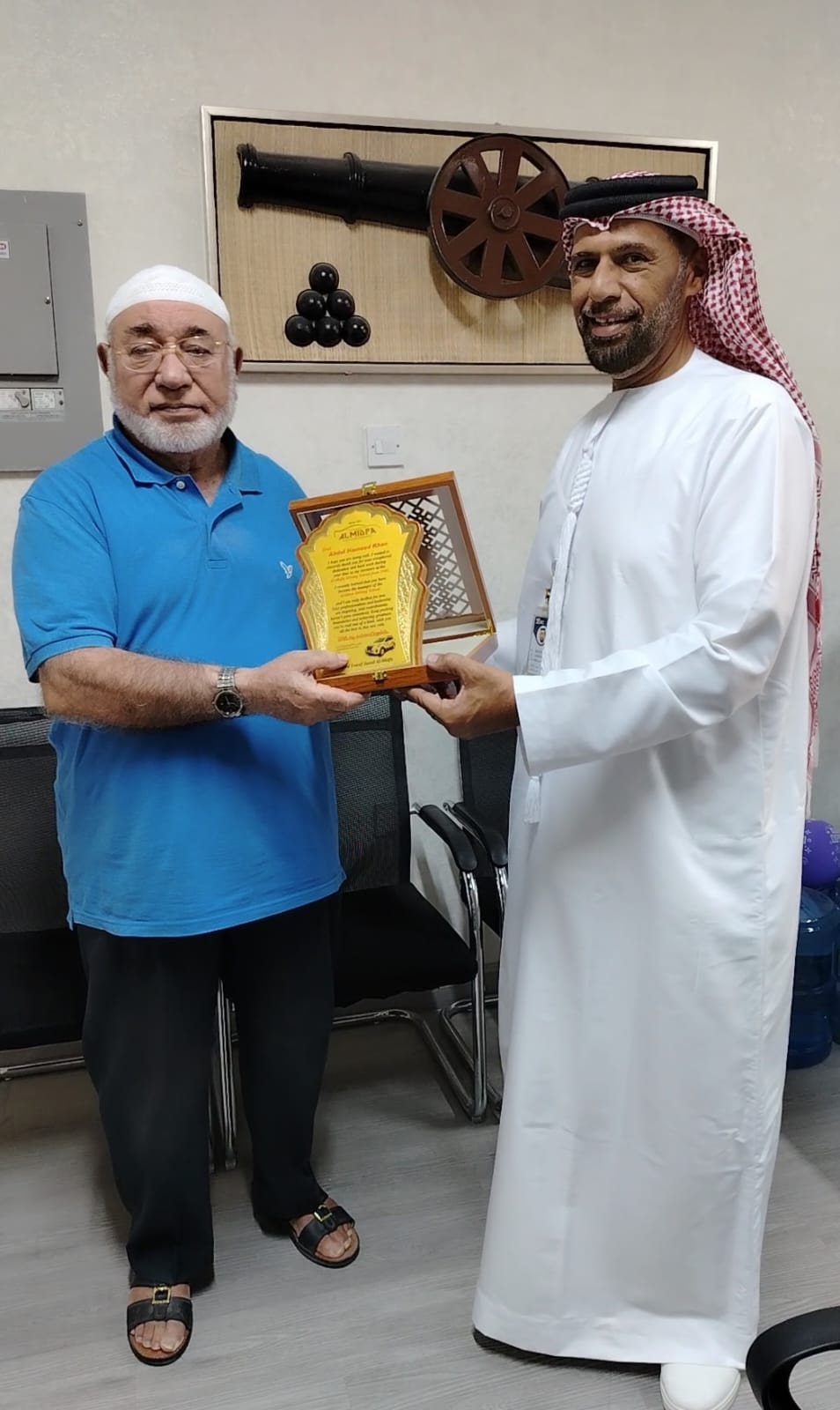 Ahmed Al Midfa presenting a recognition plaque