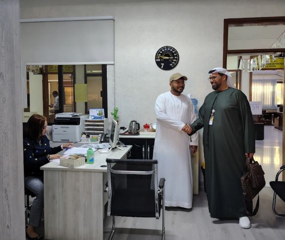 Ahmed Al Midfa welcoming a visitor at the school office
